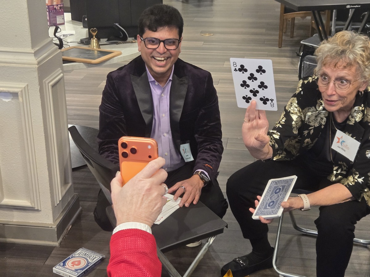 Shine performing strolling close-up magic for guests